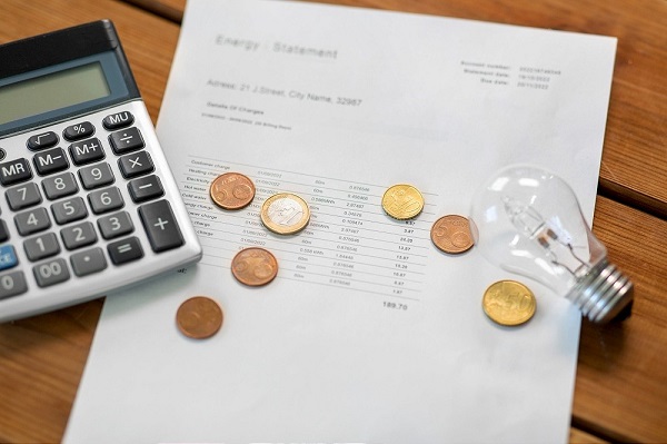 utility bill, calculator, money and lightbulb